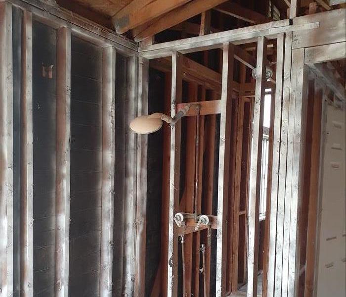 A room with out walls or insulation. Showing framing and plumbing. 
