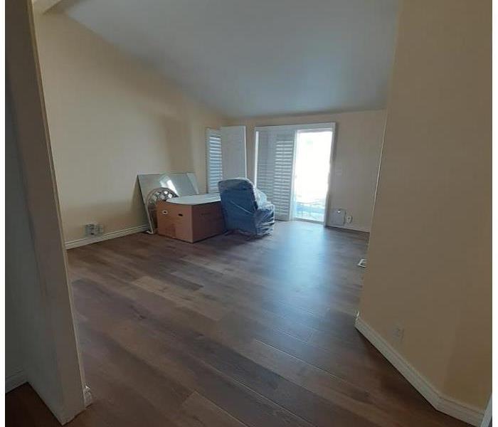 An empty room with Laminate flooring. 