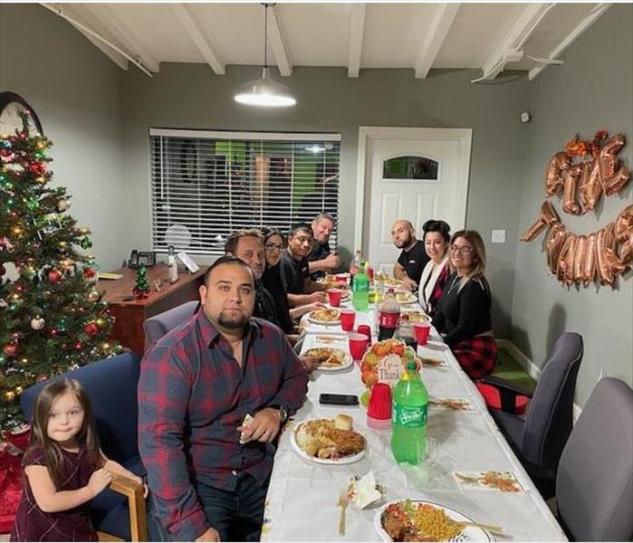 Our team sitting around our dinner table ready to eat. 